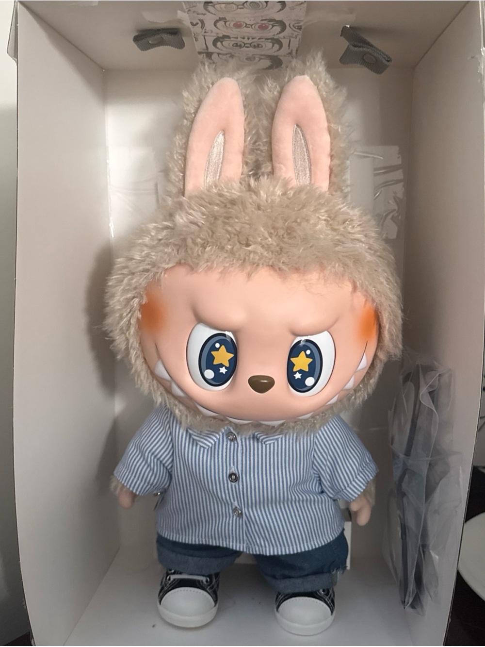 The monster Plush Bunny-Eared Star-Eye Doll in Beige Fur and Blue Outfit